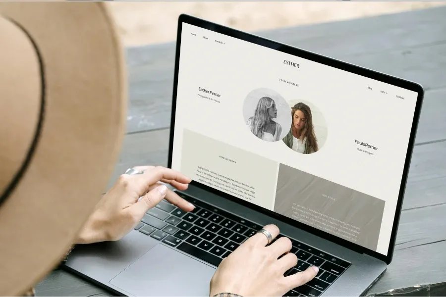 Photographer using a laptop outdoors to update a foto.umbii.boo team member profile page, showcasing a collaborative workspace for studio teams.